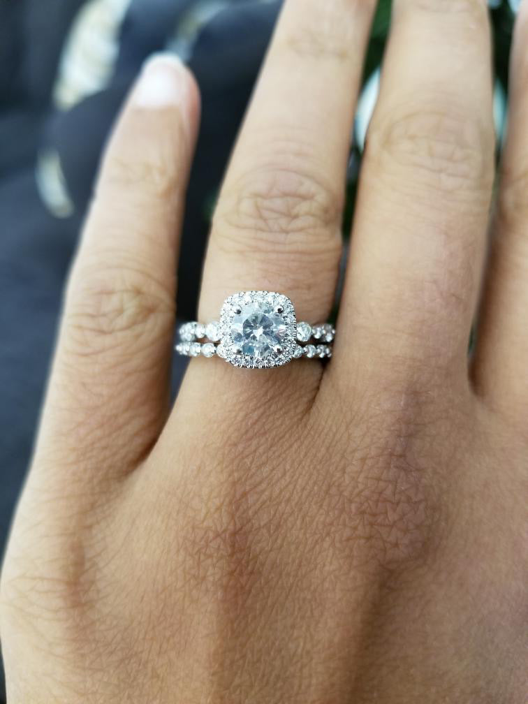 Close-up of a diamondboi cushion-cut halo engagement ring