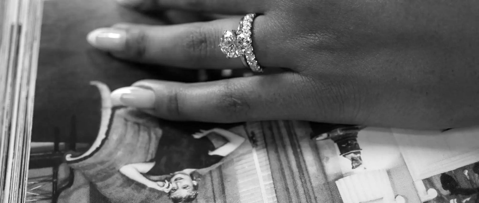 A sparkling diamond engagement ring with a central stone and halo setting.