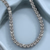 Diamond tennis necklace in 18k white gold – close-up on fabric