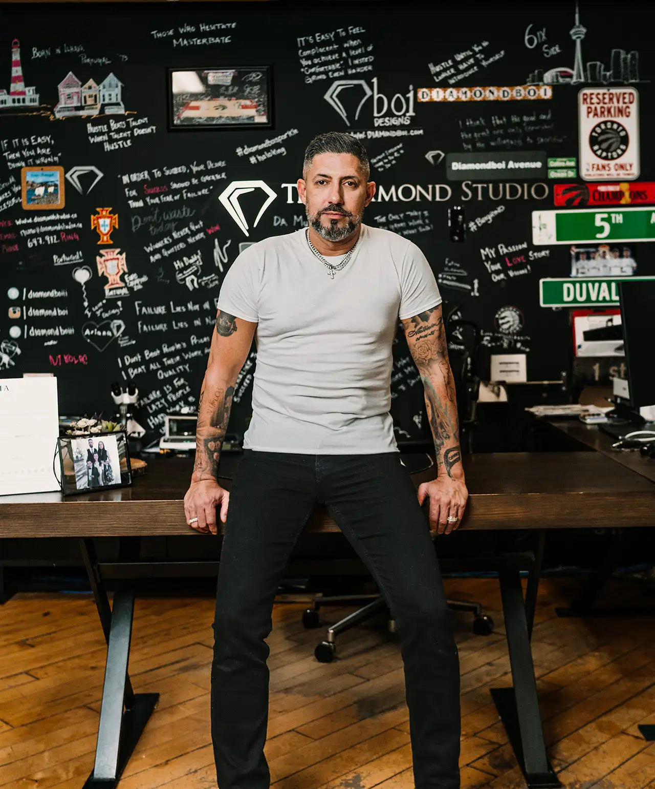 Man wearing a light gray short-sleeved t-shirt and black pants