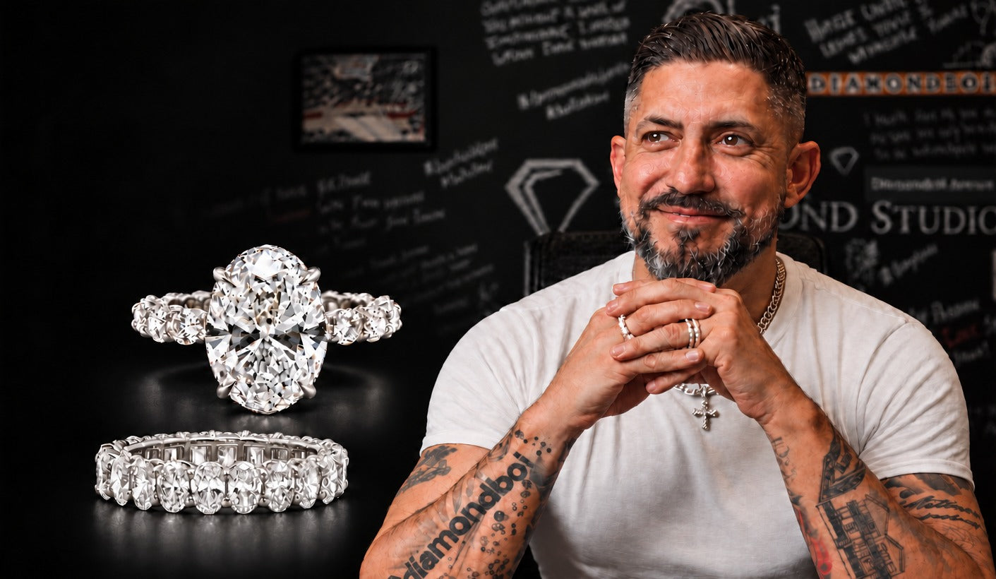 Nuno, founder of diamondboi, smiling in the Toronto studio beside an oval diamond engagement ring and eternity band