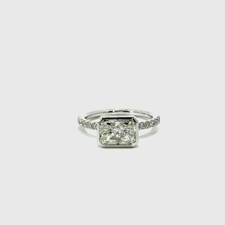 Bezel radiant cut natural diamond engagement ring, Italian pavé half-eternity shank – video