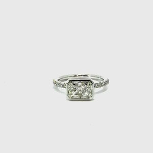 Bezel radiant cut natural diamond engagement ring, Italian pavé half-eternity shank – video