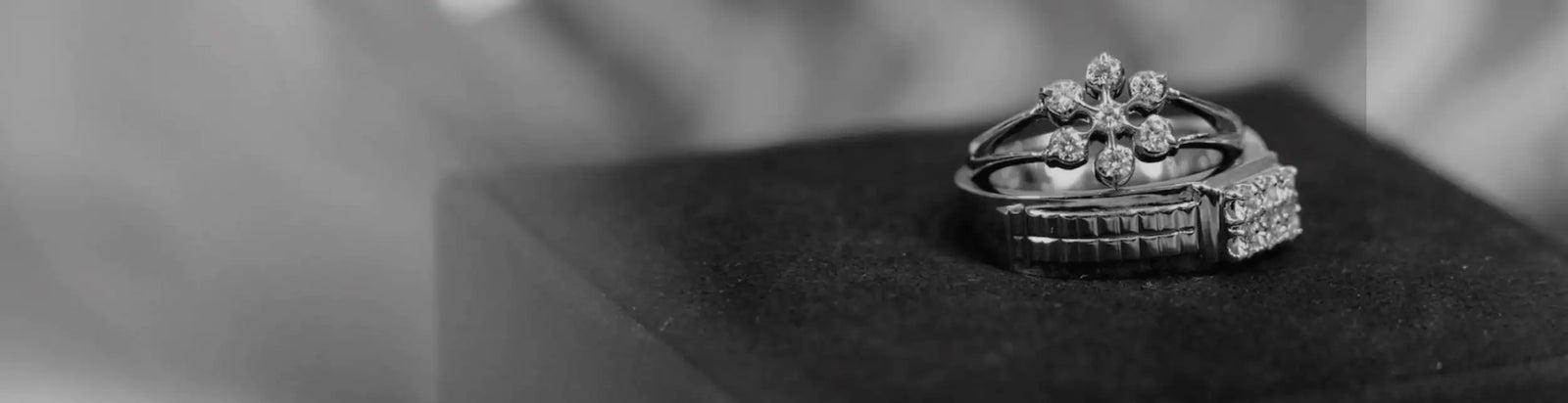 Silver diamond ring with intricate floral design and pave-set stones.